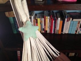 Green star hanging with ropes